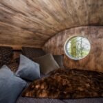 two-single-mattresses-above-the-main-living-area-inside-faraway-treehouse