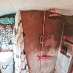 (13) Opposite the vanity, the shower and toilet.