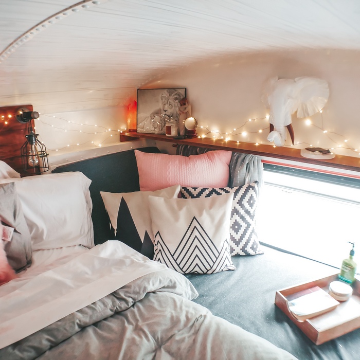 17 The reading nook over the engine compartment. - Family Bought $5K School Bus and Turned It Into Stunning Mobile Home