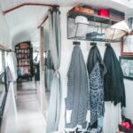 (18) A view from the back of the bus forward, looking into our closet, past the bathroom and to the pantry shelves.