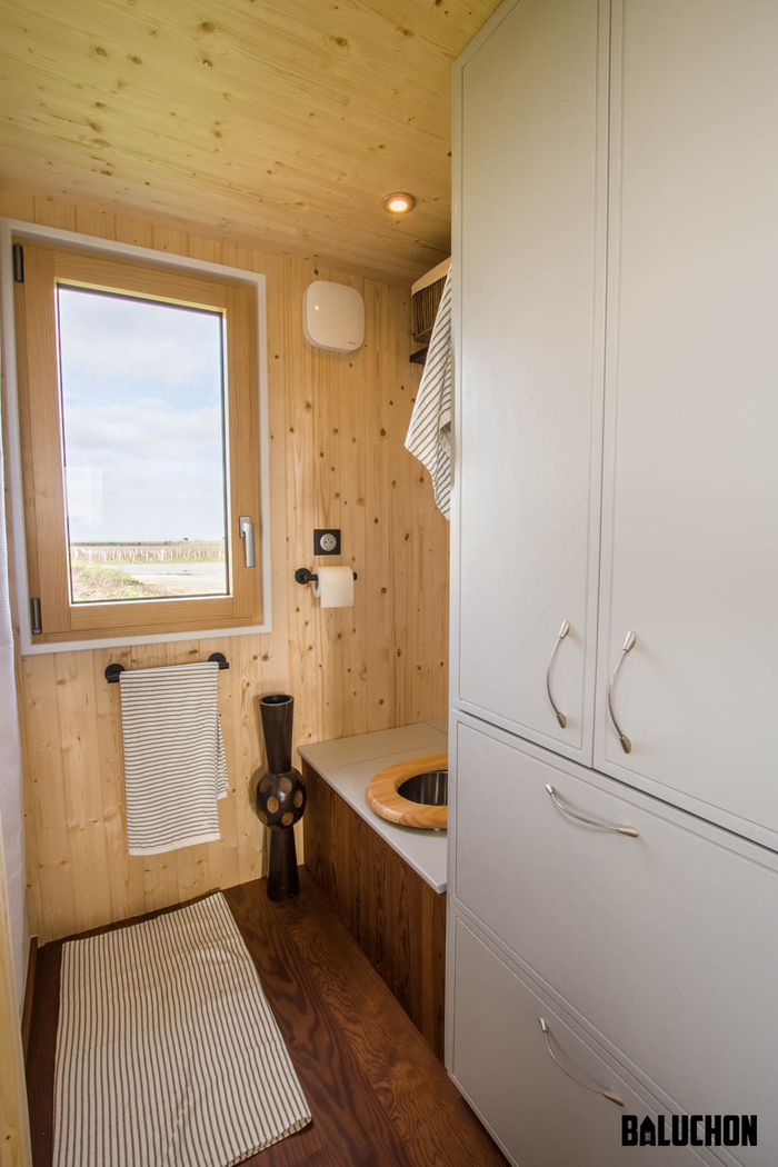 tiny house baluchon 10 - Colorful Tiny House Boasts Staircase With Built-in Dog Nook and Sitting Area