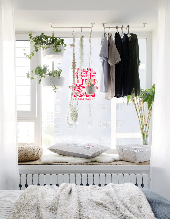 clothes-hanging-on-rails-in-a-window-alcove-2eb690df56376f70ec26c9162dd9dde8