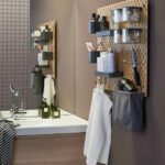 a-bathroom-with-wall-sink-unit-and-pegboard-holding-bathroom