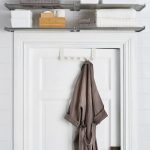 metal-shelves-are-placed-above-a-door-frame-and-store-towels-4711017916a3ede9a0a552a8e1ced9bf
