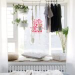 clothes-hanging-on-rails-in window