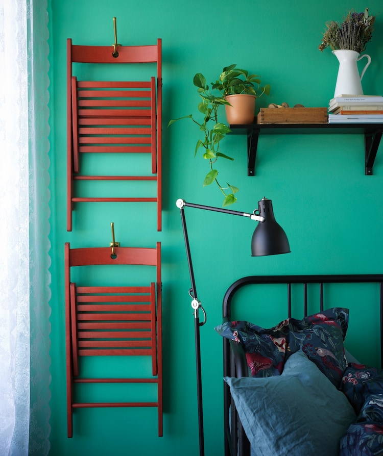 two foldable chairs hanging on a wall beside a bed a57e03a398e702fe5999090434e0e6e7 - 35 Small Bedroom Ideas – Make Every Inch Count