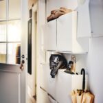 Close-up on hallway wall with many space-saving whi