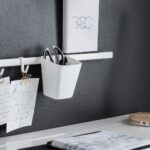 a-closeup-of-a-small-white-rail-mounted-to-a-wall-holding-a – a97cf7640f210718721ff5994e200830