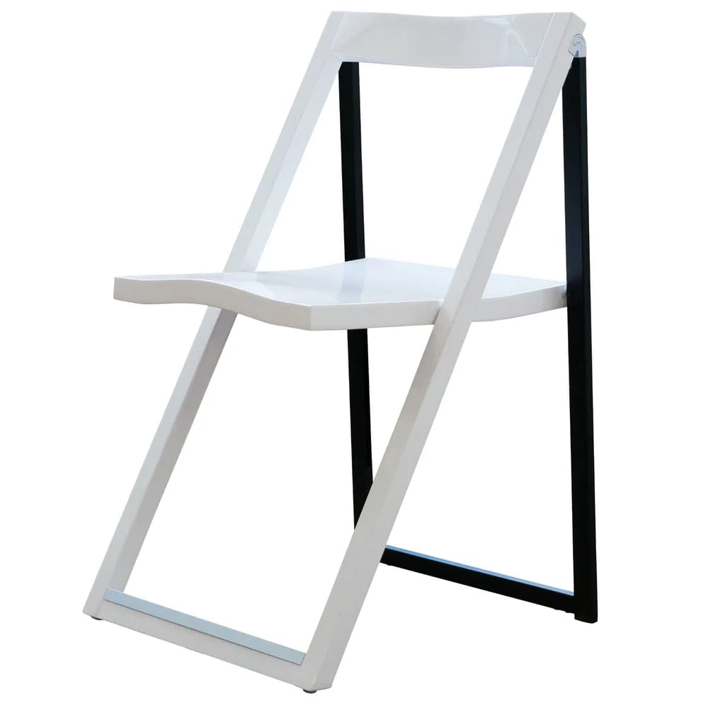A modern folding chair with a white plastic seat and backrest, and black metal legs. The design is simple and minimalistic, with the chair partially open and viewed at an angle.